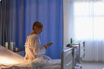 Patient-using-cell-phone-in-hospital-bed.jpg